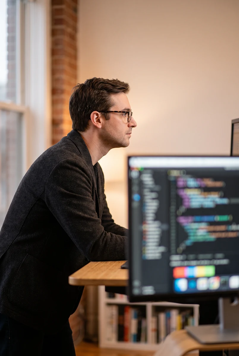 Engineer looking at code on a screen