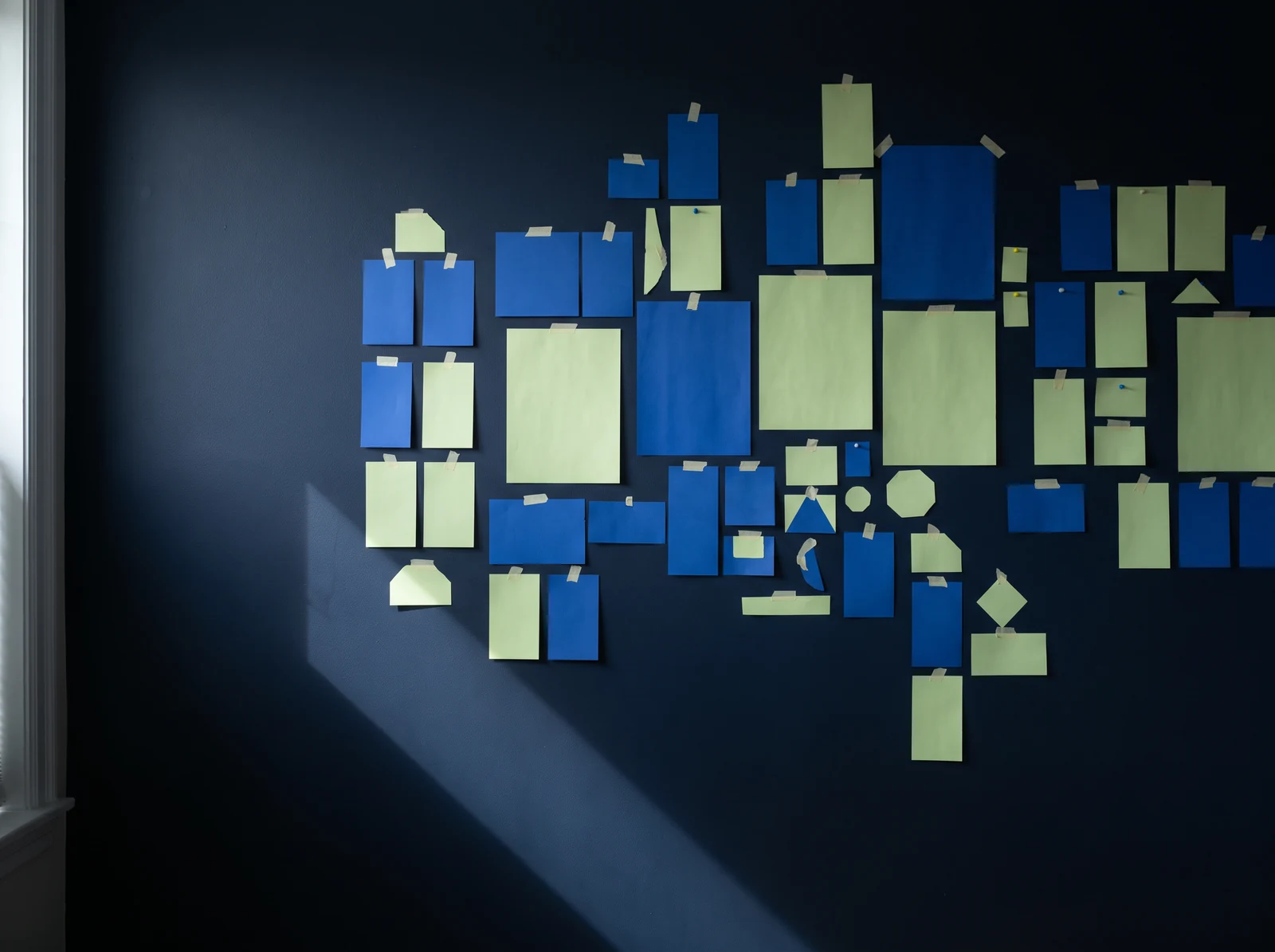 Blue and lime notes arranged on a wall